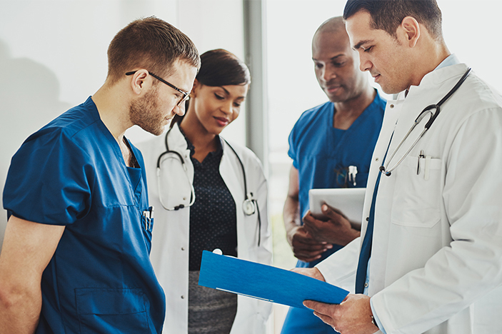 Doctor using AI on laptop in clinic